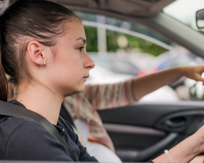 a teenage girl driving the car